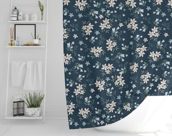 May include: A navy blue shower curtain with a white floral pattern. The flowers are small and delicate, and they are scattered randomly across the curtain.