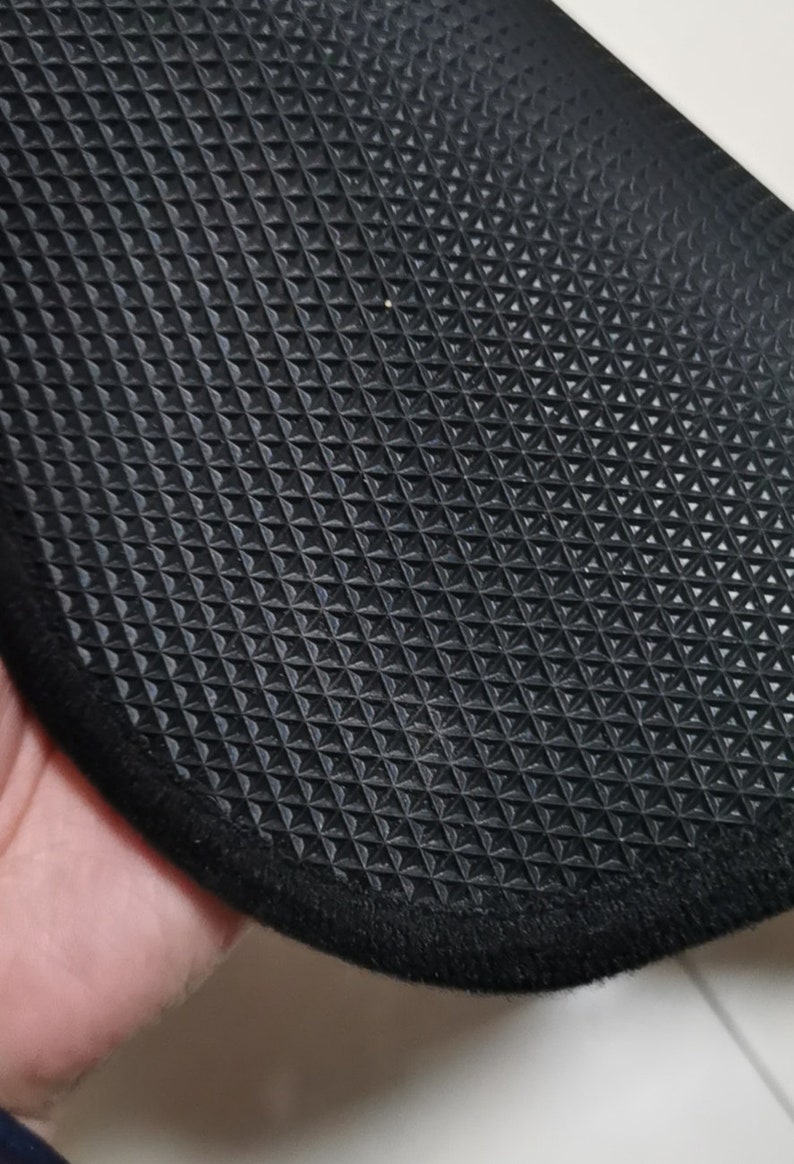 May include: Black rubber mat with a textured diamond pattern and a black fabric border.