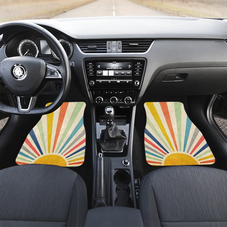 May include: A set of two car floor mats with a retro sunburst design in shades of yellow, orange, red, pink, and blue. The mats are made of a durable material and are designed to protect your car's interior.