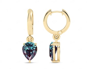 May include: Gold hoop earrings with a teardrop-shaped blue-green gemstone dangling from each hoop.