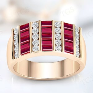 May include: A gold band ring with a row of red rectangular gemstones and a row of clear round gemstones on each side.