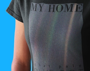 May include: Black t-shirt with the text "MY HOME" and a faded image of a pale blue dot. The text "that pale blue dot" is visible at the bottom of the image.