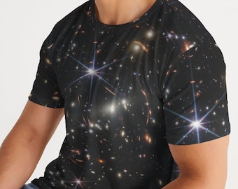 May include: A black t-shirt with a galaxy print featuring a scattering of stars and galaxies.