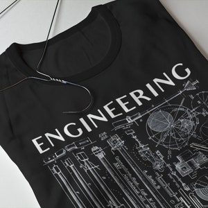 May include: Black t-shirt featuring a white print of the word "ENGINEERING" and a vintage style illustration of mechanical engineering designs.