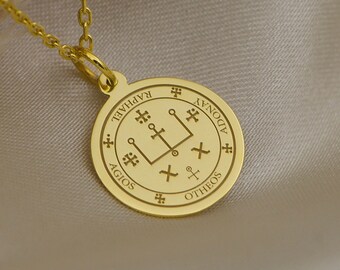 May include: Gold necklace with a round pendant featuring a sigil with the words "AGIOS", "OTHENOS", "AYDONAY", and "IAO" inscribed around the edge.