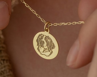 May include: A gold chain necklace with a round pendant featuring a dog's face engraved on it.