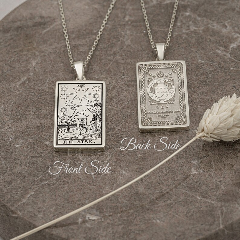 May include: A silver necklace with a pendant featuring the The Star tarot card on the front and a decorative design on the back.