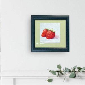 Strawberry painting. Original oil painting on cardboard of two red strawberries on a light blue background.