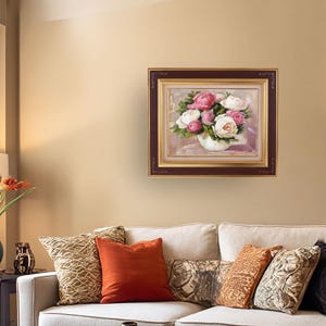 Peony oil painting original of a bouquet of peonies in a round white vase. The flowers are a mix of white and pink, with green leaves. The background is light and warm. The artist's signature is in the bottom right corner.