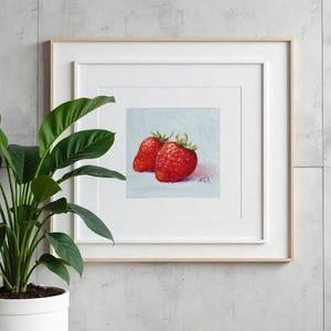Strawberry oil painting. Original oil painting on cardboard of two red strawberries on a light blue background.