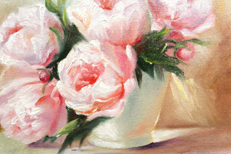 Peonies oil painting of a bouquet of pink peonies in a white vase. The flowers have multiple layers of petals and green leaves. The background is a soft, neutral color, and the painting is signed in the bottom right corner.