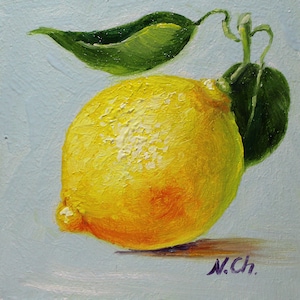 Lemon oil painting. A yellow lemon with a green leaf, painted in oil on a light blue background. The artist's signature, "N.Ch.", is in the lower right corner.