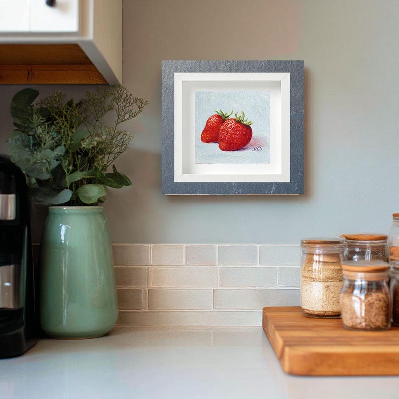 Strawberry painting. Original oil painting on cardboard of two red strawberries on a light blue background.