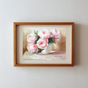 Pink peonies in a white vase. The floral artwork features a light background. The flowers are the focal point, with detailed brushstrokes capturing their delicate petals and green leaves.