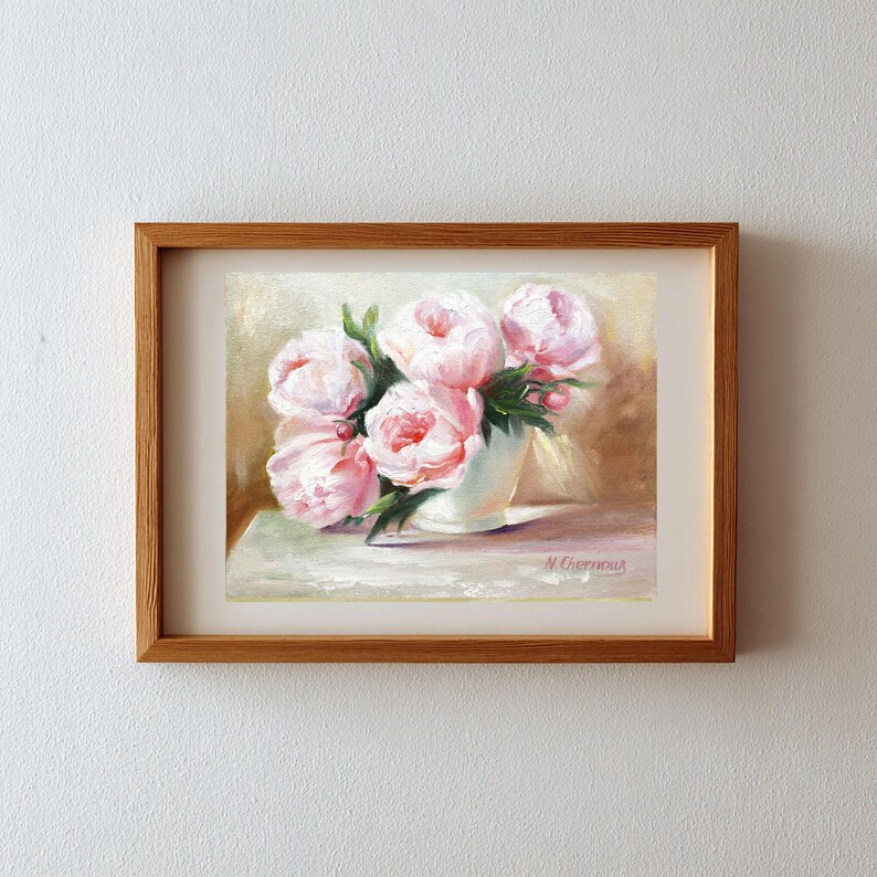 Pink peonies in a white vase. The floral artwork features a light background. The flowers are the focal point, with detailed brushstrokes capturing their delicate petals and green leaves.