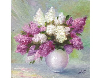 May include: Oil painting of a bouquet of lilacs in a white vase. The flowers are a mix of white and purple, with green leaves. The vase is round and sits on a light blue surface. The background is a soft blend of green and blue.