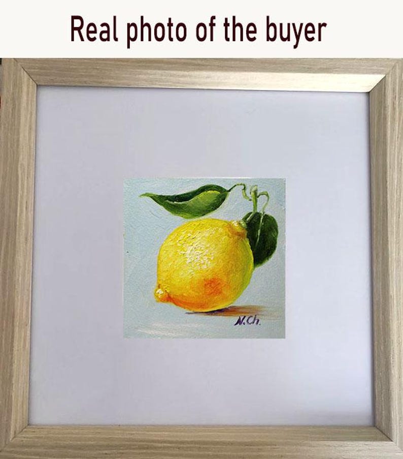 Lemon oil painting. A yellow lemon with a green leaf, painted in oil on a light blue background. The artist's signature, "N.Ch.", is in the lower right corner.