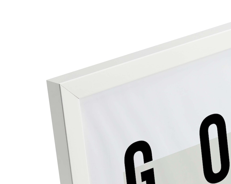 May include: White picture frame with a black and white print of the word "GOOD" inside. The frame has a simple, modern design.