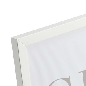 May include: White picture frame with a white mat and a white background. The frame is made of wood and has a simple design. The frame is empty and ready to be filled with a picture or artwork.