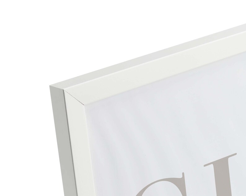 May include: White picture frame with a white mat and a white background. The frame is made of wood and has a simple design. The frame is empty and ready to be filled with a picture or artwork.