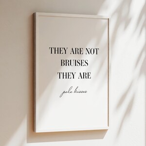 May include: A white framed print with black text that reads "They are not bruises they are pole kisses".