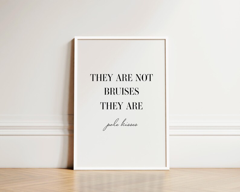 May include: A white framed print with the text "They are not bruises they are pole kisses" in black font.