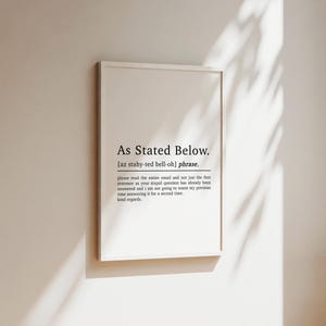 May include: A white framed print with black text that reads "As Stated Below."  The text is defined as a phrase and includes the phonetic pronunciation. The text continues with a humorous message about an email and a request to read the entire email before responding.