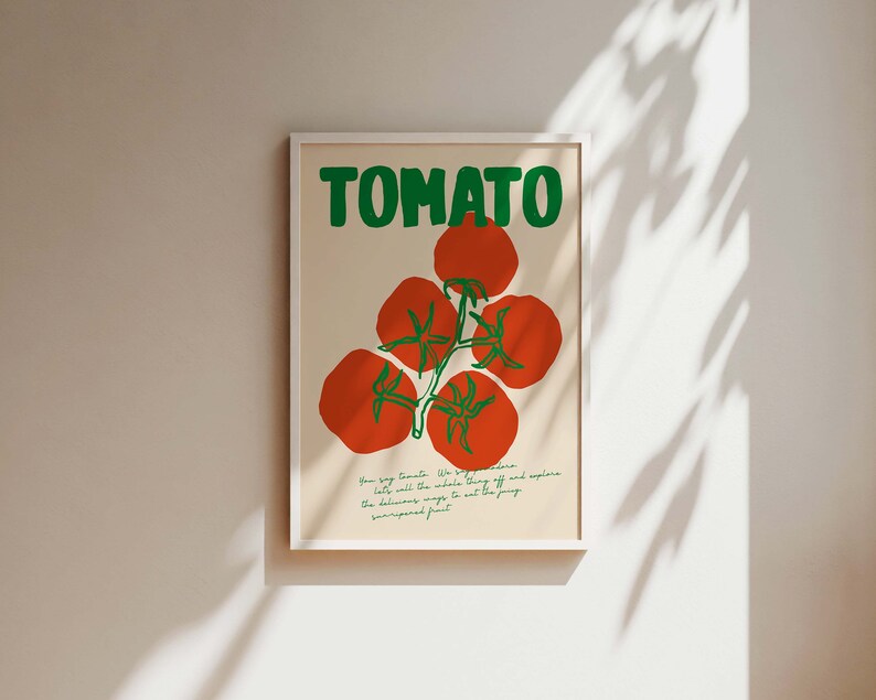May include: A white framed poster with the word "TOMATO" in green letters and a red tomato illustration. The text below the illustration reads "How big Tomato. We say, "go ahead, let's eat the whole thing" off and explore the delicious ways to eat this juicy sun-ripened fruit."