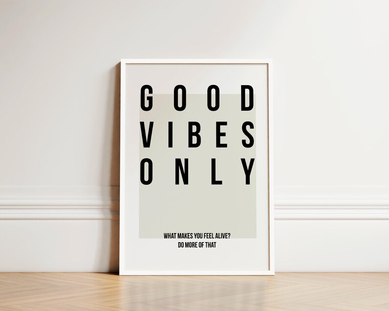 May include: A white framed print with the text "GOOD VIBES ONLY" in black letters. The print also includes the text "WHAT MAKES YOU FEEL ALIVE? DO MORE OF THAT."