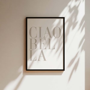 May include: A black framed print with the text "CIAO BELLA" in white on a white background.