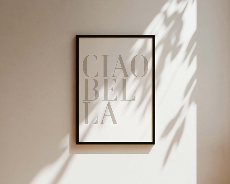 May include: A black framed print with the text "CIAO BELLA" in white on a white background.
