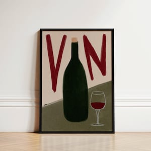May include: Framed art print depicting a dark green wine bottle with a cork, a glass of red wine, and the word "VN" in red. The background has a neutral colour palette with a black frame.