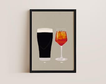 May include: A framed print featuring two cocktail illustrations. One is a dark stout with a white head, labeled "BAS.", and the other is a red cocktail with ice, labeled "HEAD.". The background is a neutral beige.