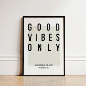 May include: Black framed print with a white background and the text "GOOD VIBES ONLY" in black. The text is in a grid pattern. Below the text is the phrase "WHAT MAKES YOU FEEL ALIVE? DO MORE OF THAT."