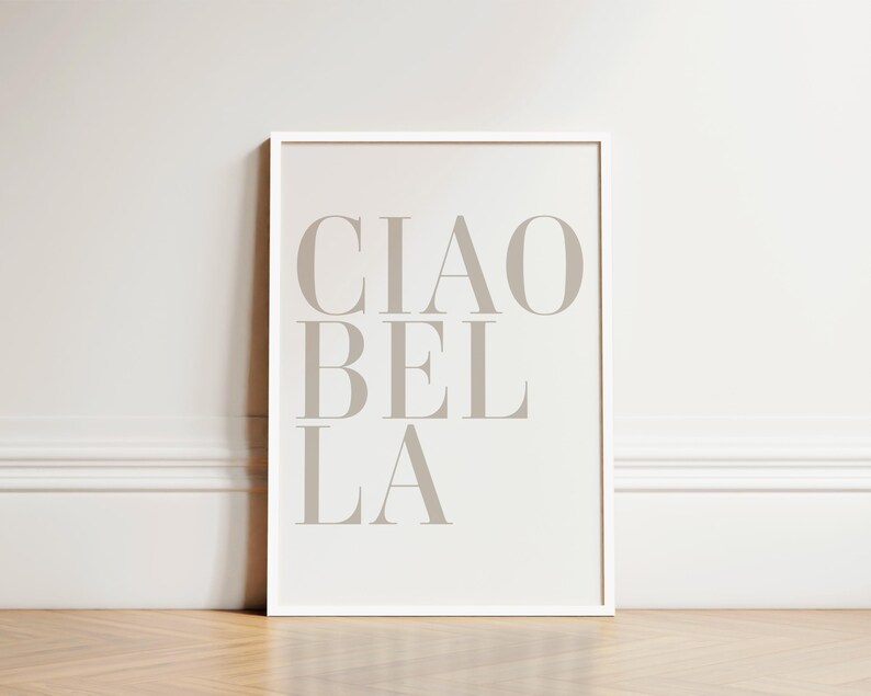 May include: A white framed print with the text "CIAO BEL LA" in a light gray color.