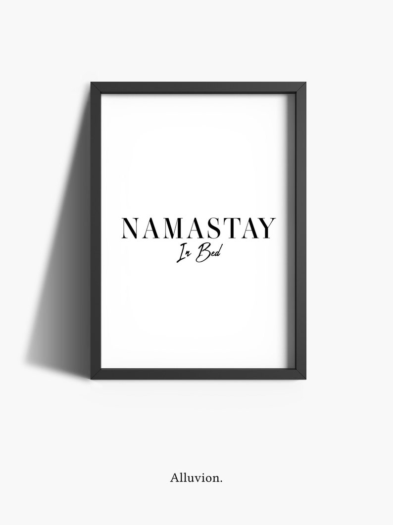 May include: Black and white framed print with the text "NAMASTAY In Bed" in a modern font.