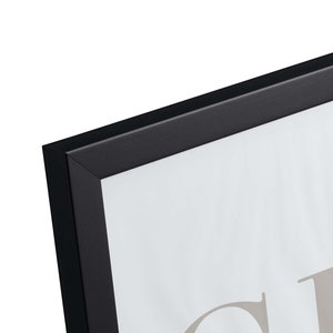 May include: Black picture frame with a white mat and a blank white space for a photo or artwork. The frame is made of wood and has a simple, modern design.