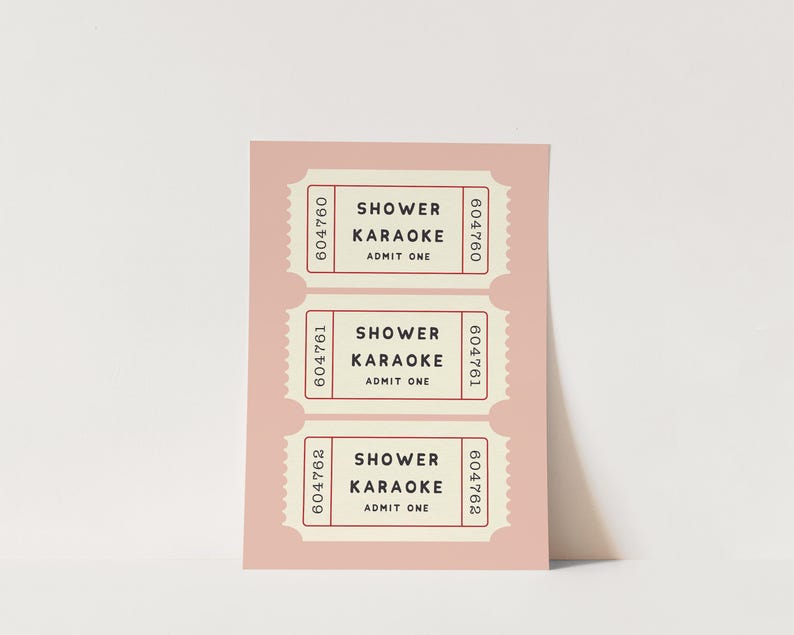 May include: A blush pink card with three retro-style tickets. Each ticket reads "SHOWER KARAOKE ADMIT ONE" in a serif font. The tickets have a cream-colored background and a red border with a unique serial number.