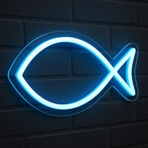 May include: A neon blue Ichthys symbol, a Christian fish symbol, against a dark grey brick wall. The sign has a bright, glowing outline, creating a striking contrast against the textured background. The fish shape is a classic religious symbol.