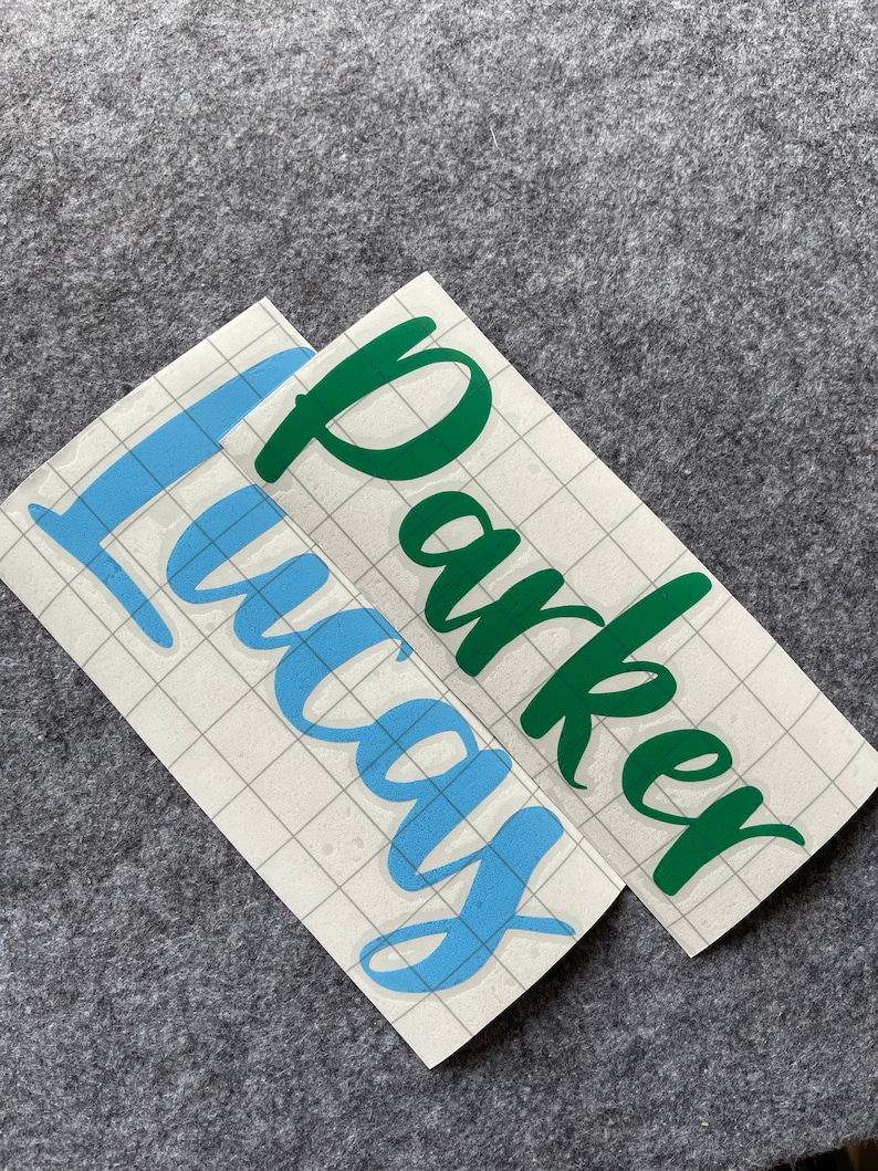 May include: Two vinyl decals, one with the name "Lucas" in light blue and the other with the name "Parker" in dark green.