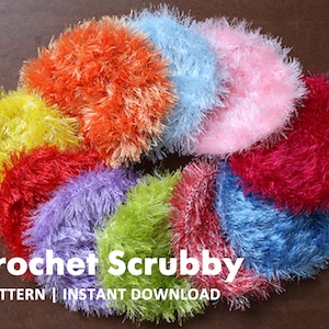 May include: A collection of colorful crocheted scrubby sponges in various colors, including yellow, orange, blue, pink, red, purple, and green. The scrubbies are arranged in a circle on a brown surface. The text "Crochet Scrubby PATTERN | INSTANT DOWNLOAD" is visible below the scrubbies.
