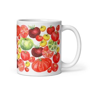 May include: White ceramic mug with a colorful pattern of red, green, yellow, and orange tomatoes. The tomatoes are arranged in a random pattern on the mug.