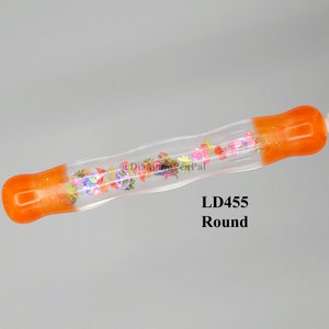 May include: A clear, round pen with orange glitter accents on the ends. The pen's interior features colorful floral designs and the text "LD455 Round".