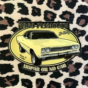 May include: A yellow 1969 Plymouth B-Body car sticker with the text "Mopar or No Car" and "Atomic Gearheads" in a black oval.