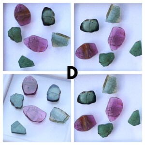 May include: A collection of colourful gemstones in a white tray. The stones are various shapes and colours, including pink, green, blue, and brown. The letter "D" is visible in the image.