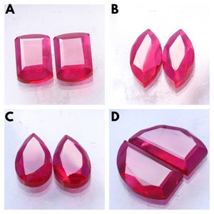 May include: Four pairs of red gemstones, each pair is a different cut. The first pair is square, the second is marquise, the third is pear-shaped, and the fourth is a half-circle.