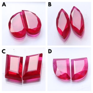 May include: Four pairs of ruby gemstones, each pair is cut in a different shape. The shapes are: pear, marquise, emerald, and half-moon.