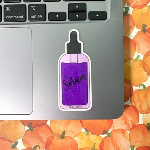 Sticker for this listing next to a laptop touchpad