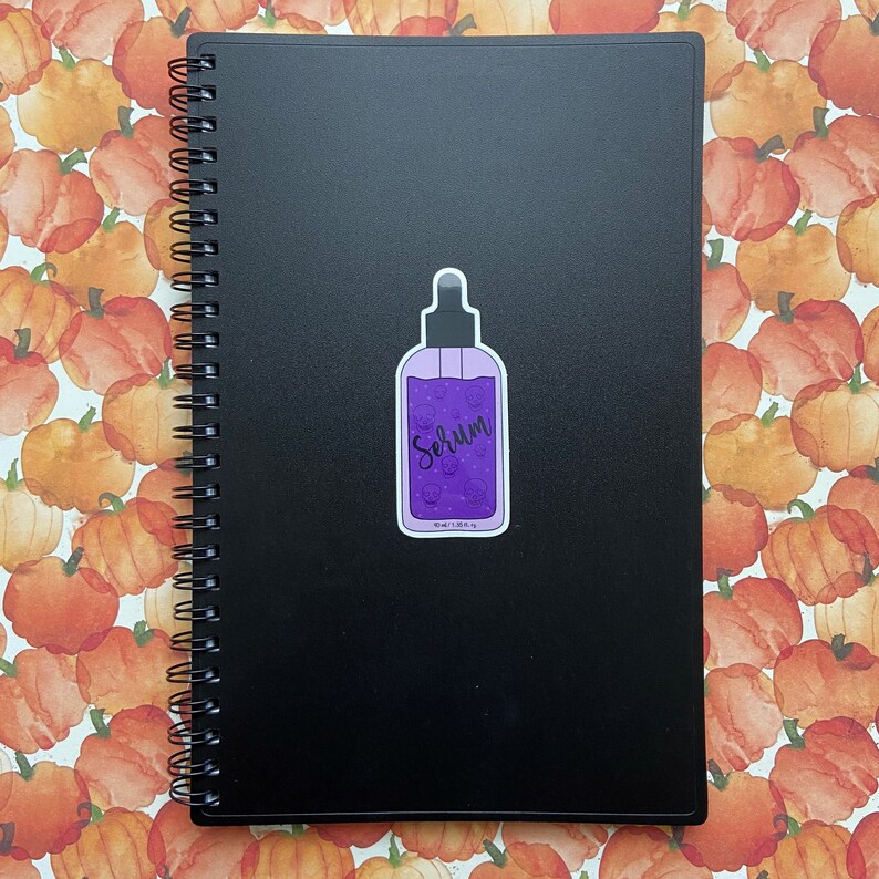 Sticker for this listing on a black spiral notebook cover