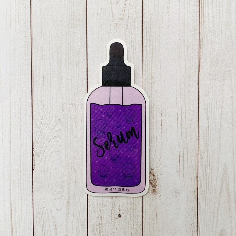 Vinyl sticker of purple bottle with purple liquid that has skulls inside labeled serum in black cursive text